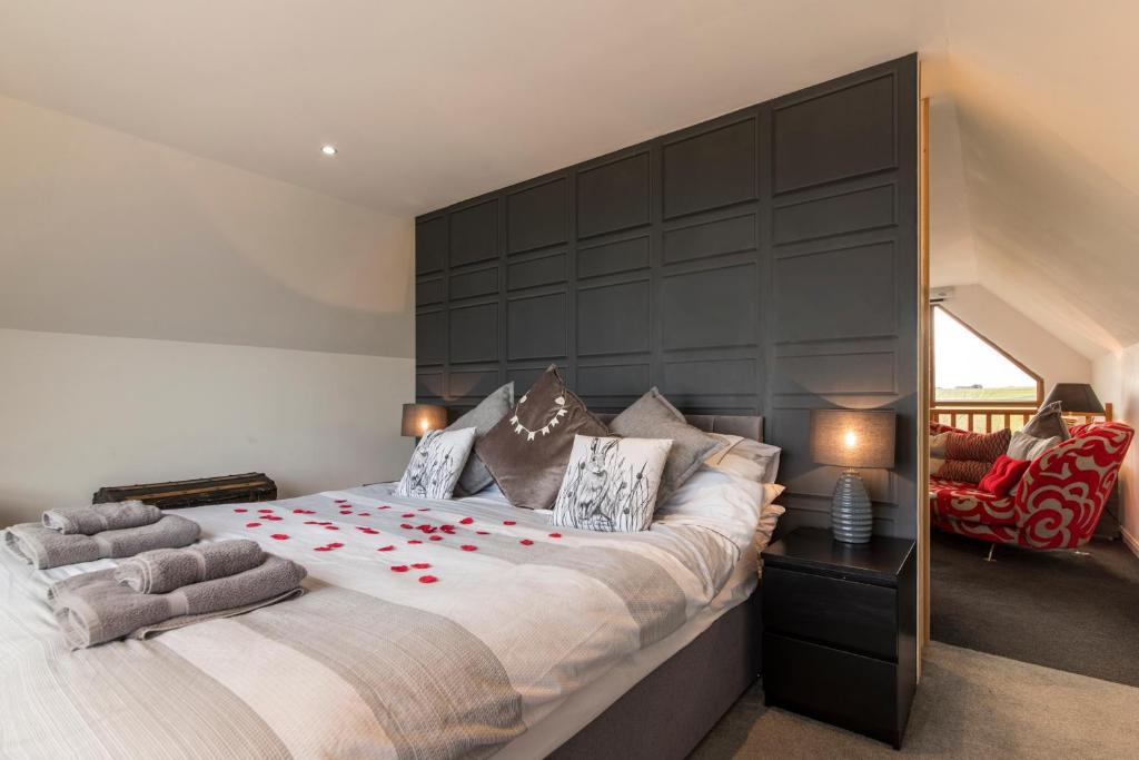 a bedroom with a large bed with red roses on it at Valleyview House in Thurso