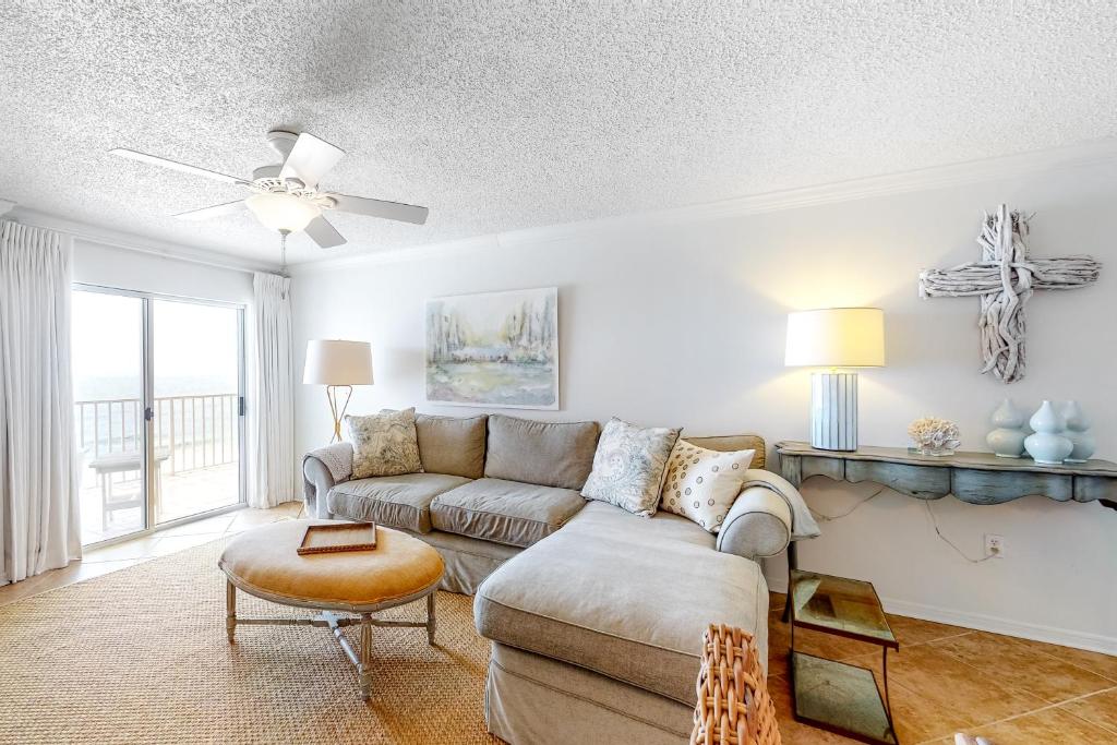 a living room with a couch and a table at Ocean House in Gulf Shores