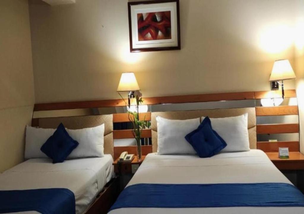 Postel nebo postele na pokoji v ubytování Blue Star Hotel