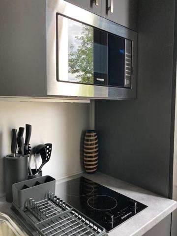 a kitchen with a stove top and a microwave at Le Select Studio in Dieppe