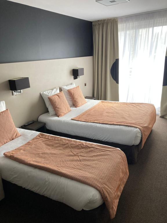 Postel nebo postele na pokoji v ubytování Hotel Georges