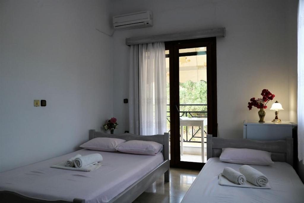 Postel nebo postele na pokoji v ubytování Hotel Akropolis