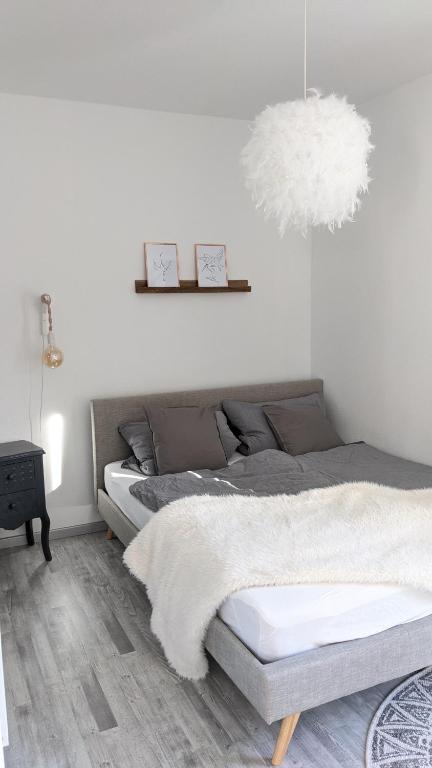 a bedroom with two beds and a pendant light at Ferienwohnung Kern Hitzacker in Hitzacker