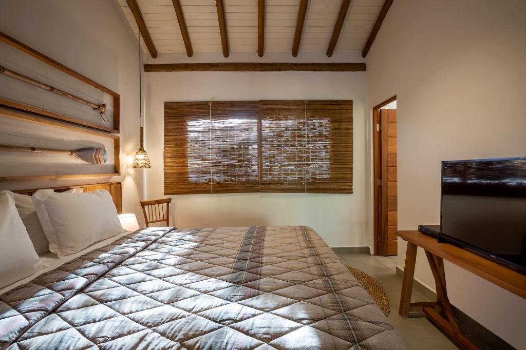 Postel nebo postele na pokoji v ubytování Flamboyant Residence Quadrado