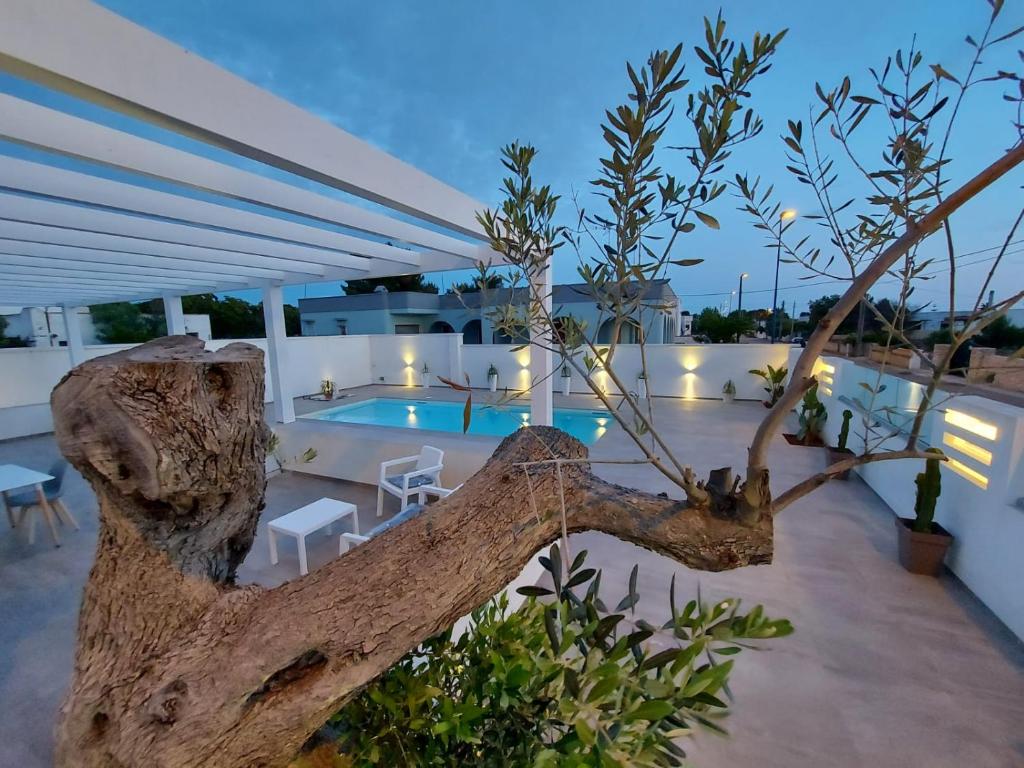 a view of a pool from a house with a tree at Elite Luxury Residence in Torre Suda