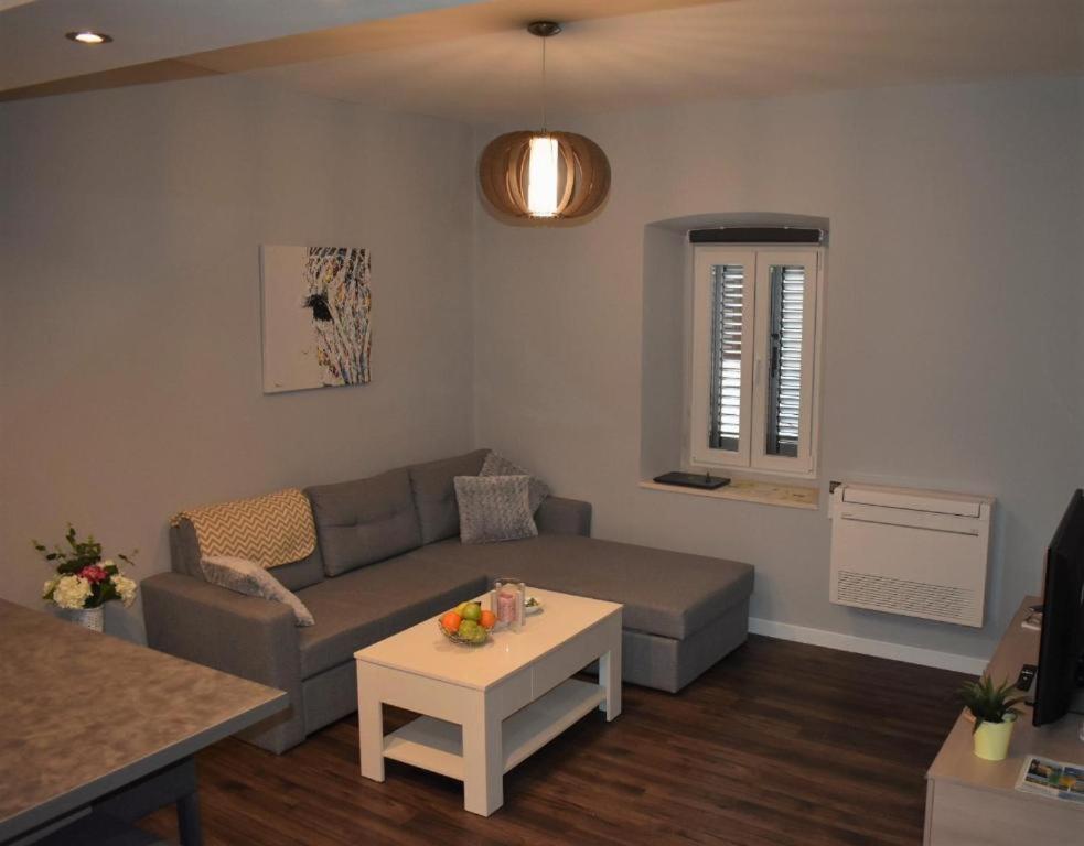 a living room with a couch and a table at Apartmani Trklja in Trebinje