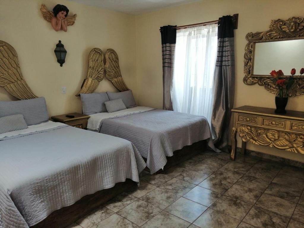 Postel nebo postele na pokoji v ubytování Hotel Chely