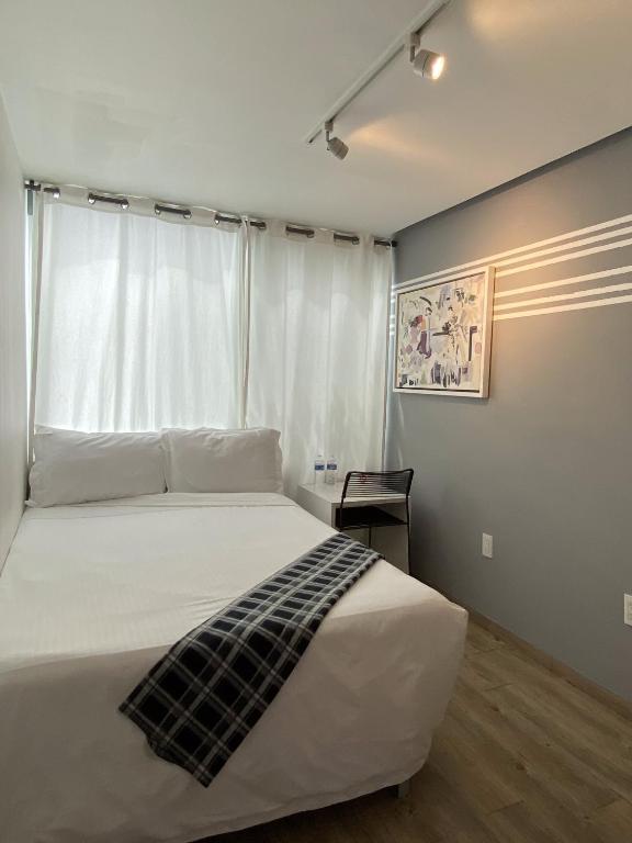 Postel nebo postele na pokoji v ubytování Kubo Hotel