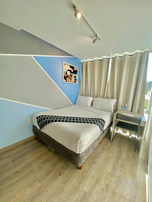 Postel nebo postele na pokoji v ubytování Kubo Hotel