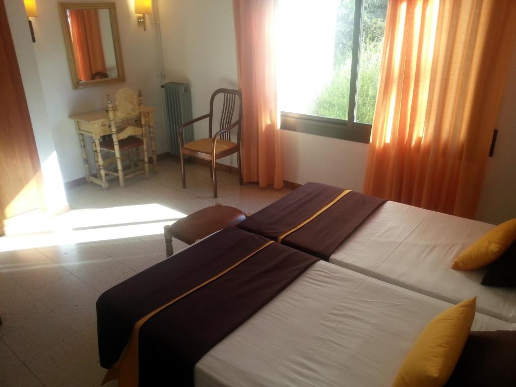 Postel nebo postele na pokoji v ubytování Hotel Hostal del Sol