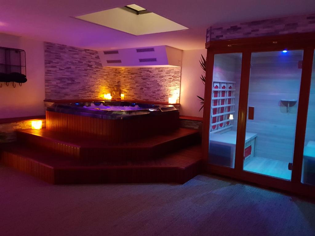 a room with a stone wall and a room with stairs at Suite room jacuzzi sauna privatif illimité Clisson in Clisson