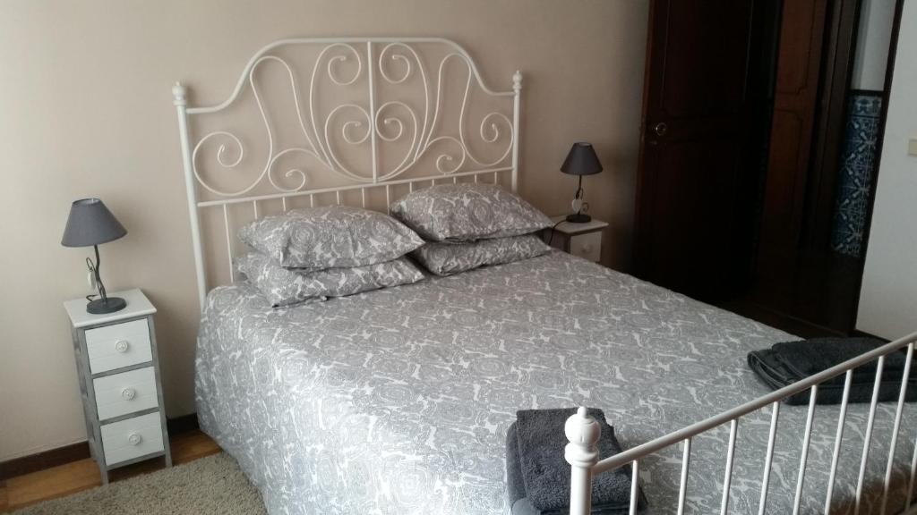 a bedroom with a white bed with pillows on it at Spacious Central 2 Bedroom Apartment in Setúbal