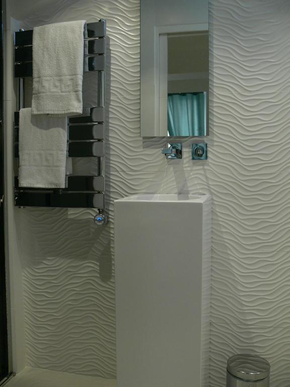 a bathroom with a sink and a mirror and towels at Stone studio in Saint-Tropez