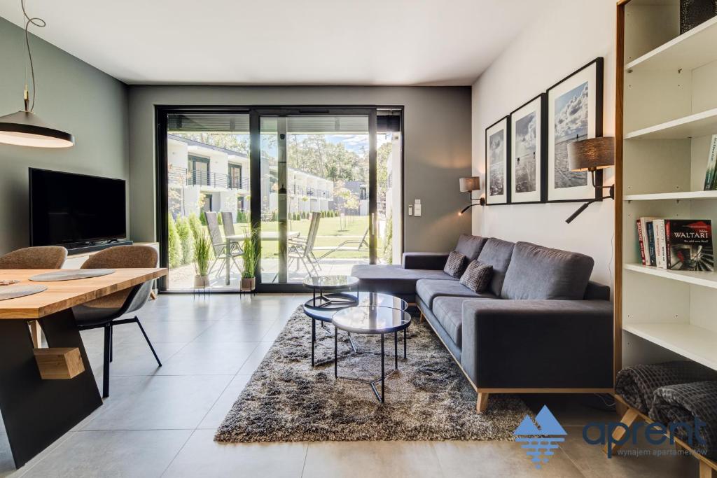 a living room with a couch and a table at Dom FANØ Baltic 2 - Aprent in Pobierowo