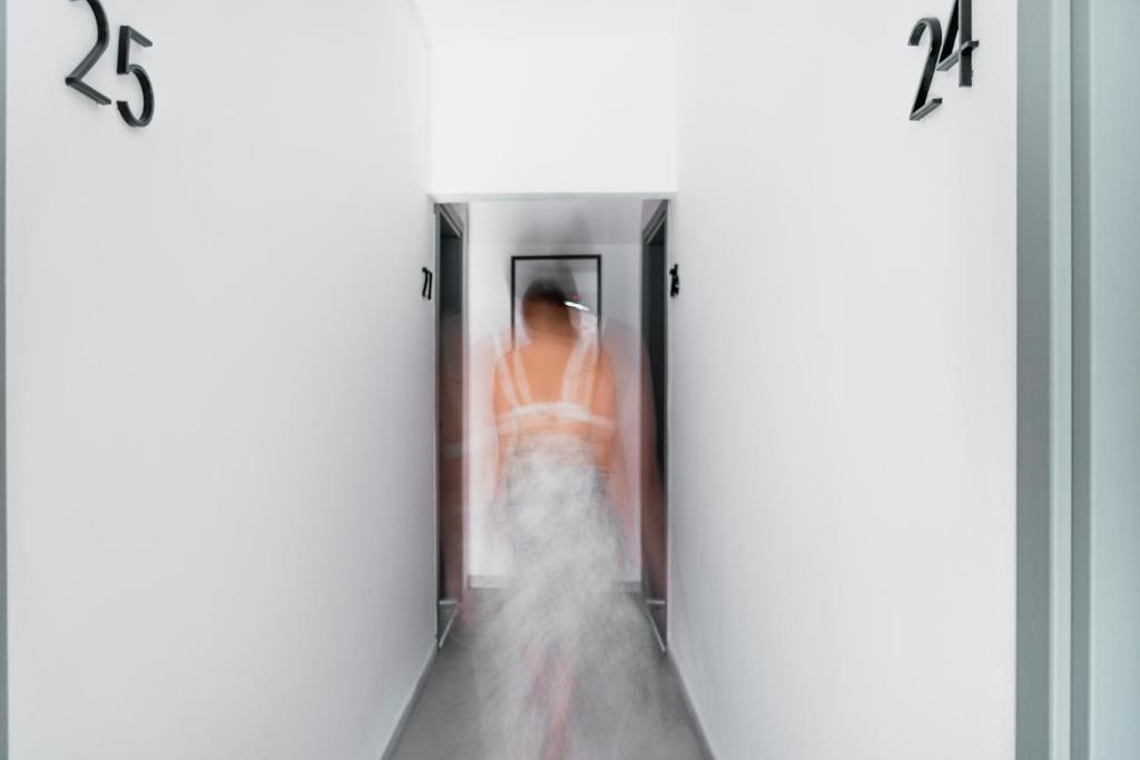a woman walking down a hallway in an elevator at Seaside Suites in Kavos