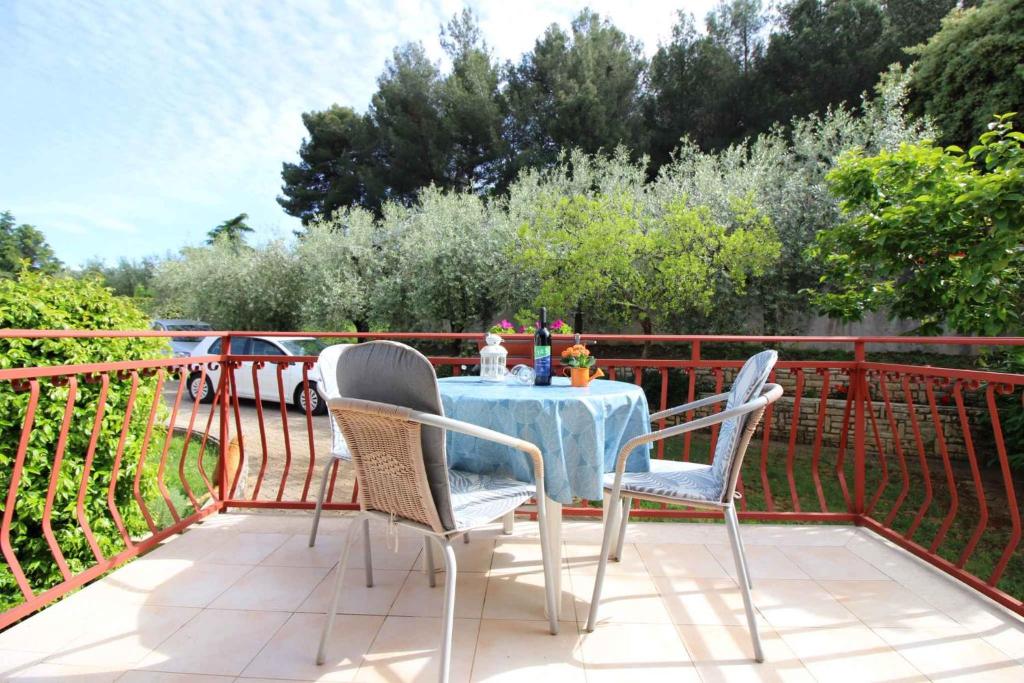 a table and two chairs on a balcony with a table and chairs at Apartment in Porec/Istrien 10068 in Poreč