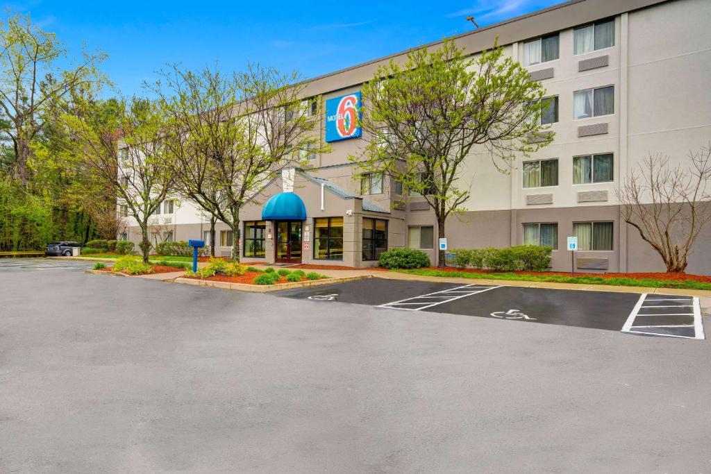 a hotel with a parking lot in front of it at Motel 6-Milford, CT in Milford