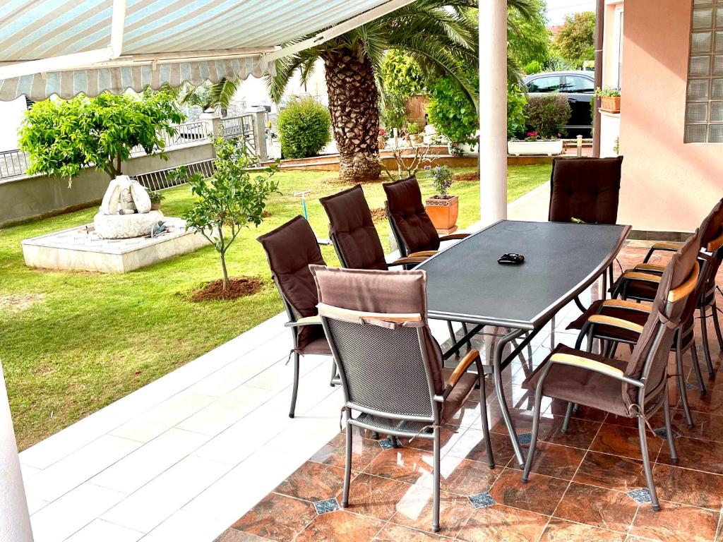 a black table and chairs on a patio at D&A Apartment with private swimming pool in Pula