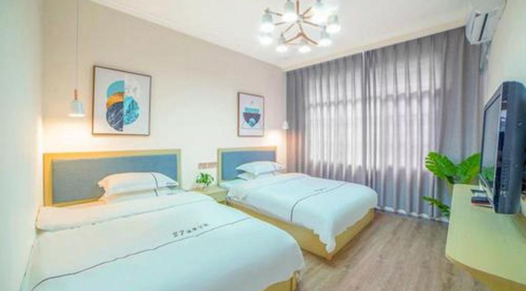 Postel nebo postele na pokoji v ubytování One Meter Sunshine Hotel Xi'an Xianyang International Airport Flagship Store