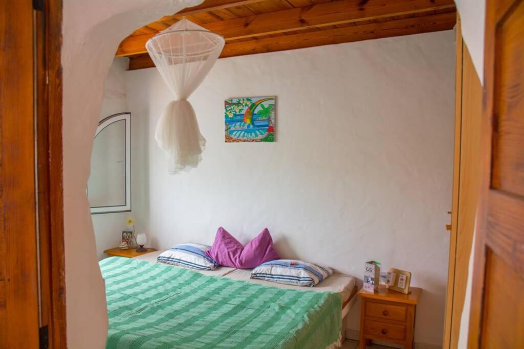 a bedroom with two beds and a net at Casa Madre Tierra in La Pared