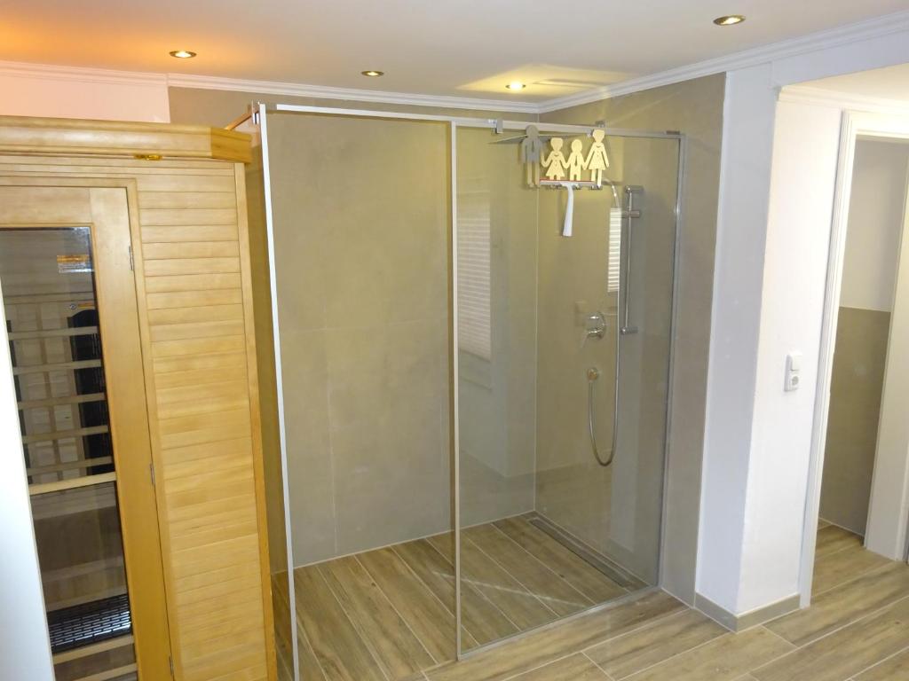 a shower with a glass door in a bathroom at Ferienhaus Strandoase in Oldenburg in Holstein