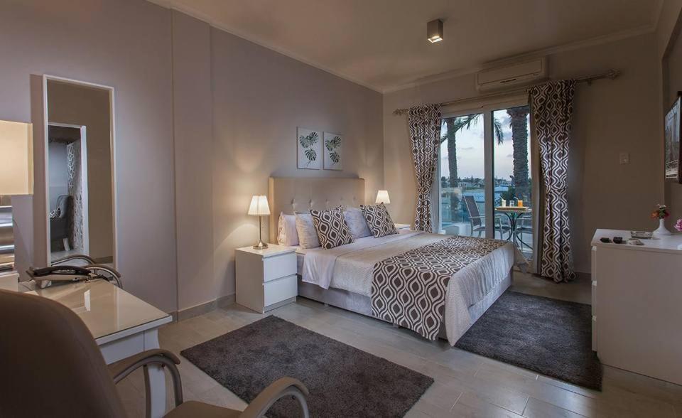 a bedroom with a bed and a balcony at Sea Gull Marina Hotel in El Alamein