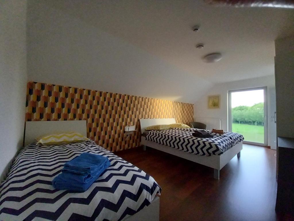 Postel nebo postele na pokoji v ubytování Les jardins du Gauquier