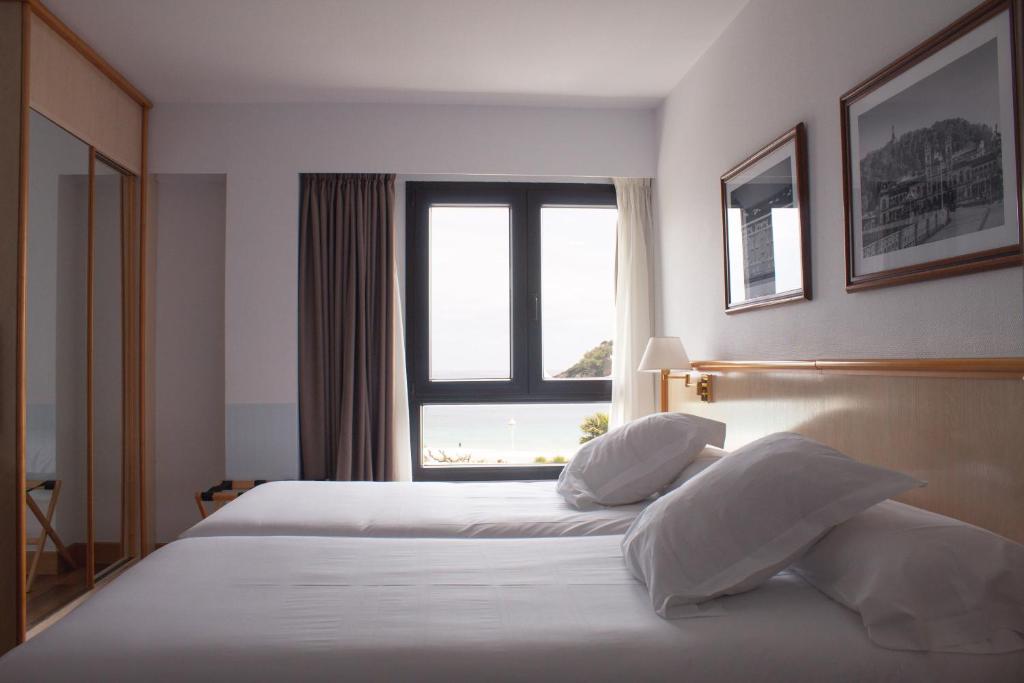 Postel nebo postele na pokoji v ubytování Hotel Ezeiza