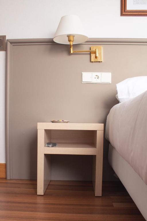 Postel nebo postele na pokoji v ubytování Hotel Ezeiza