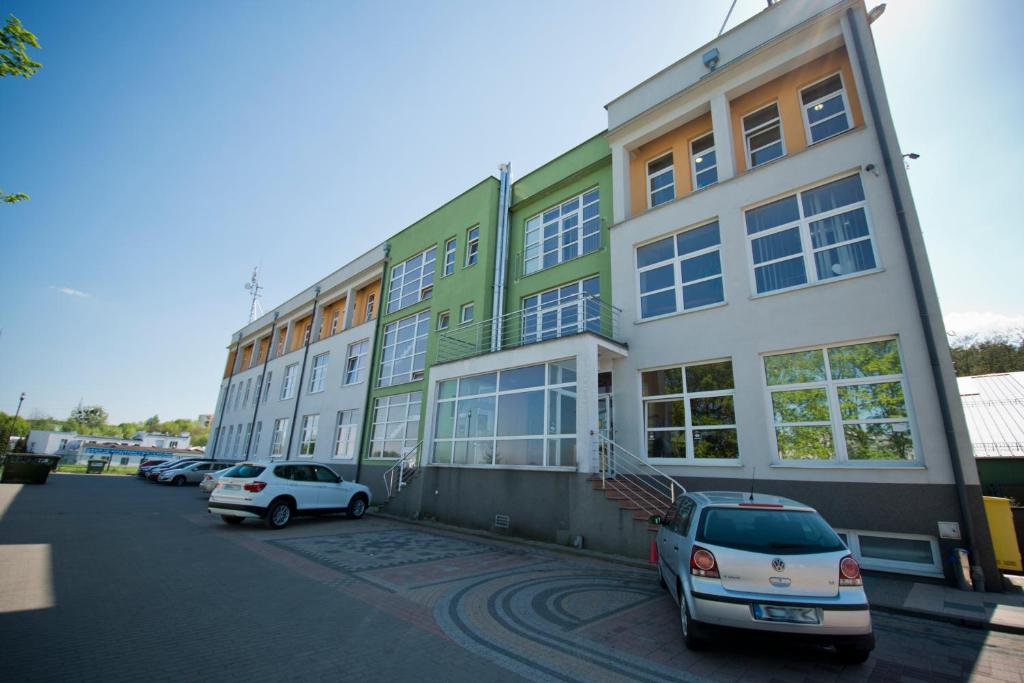 budynek z samochodami zaparkowanymi na parkingu w obiekcie Hotel Centrum w Bydgoszczy