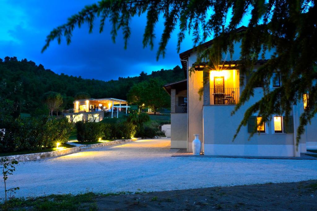 a house with lights on the side of it at night at Fontepino in Crocemaroggia