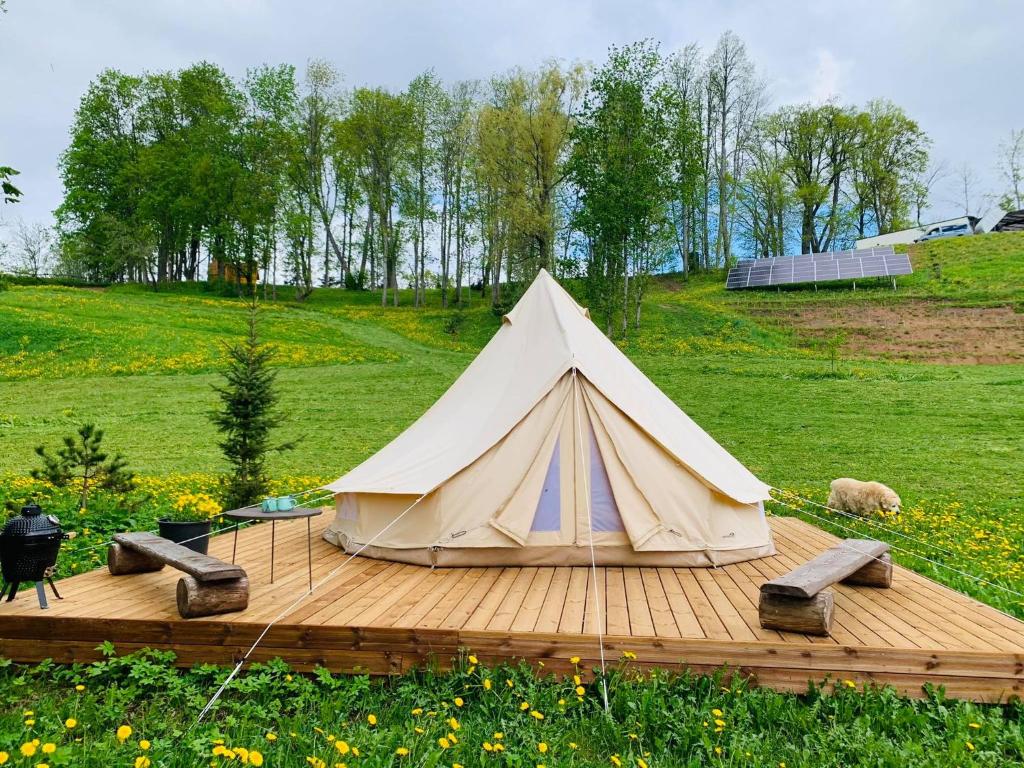 a white tent sitting on a wooden deck at Murimäe Winery glamping in Otepää