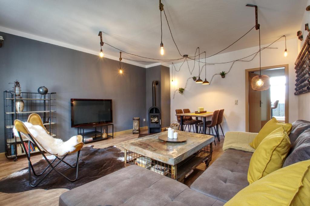 a living room with a couch and a table at Ferienwohnung LOFT STUDIO ANNABERG in Annaberg-Buchholz