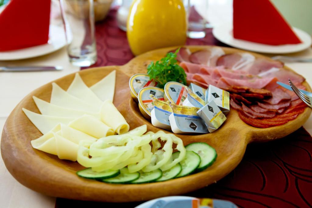 a plate of food with cheese and meats on a table at Mathias Rex in Szentendre