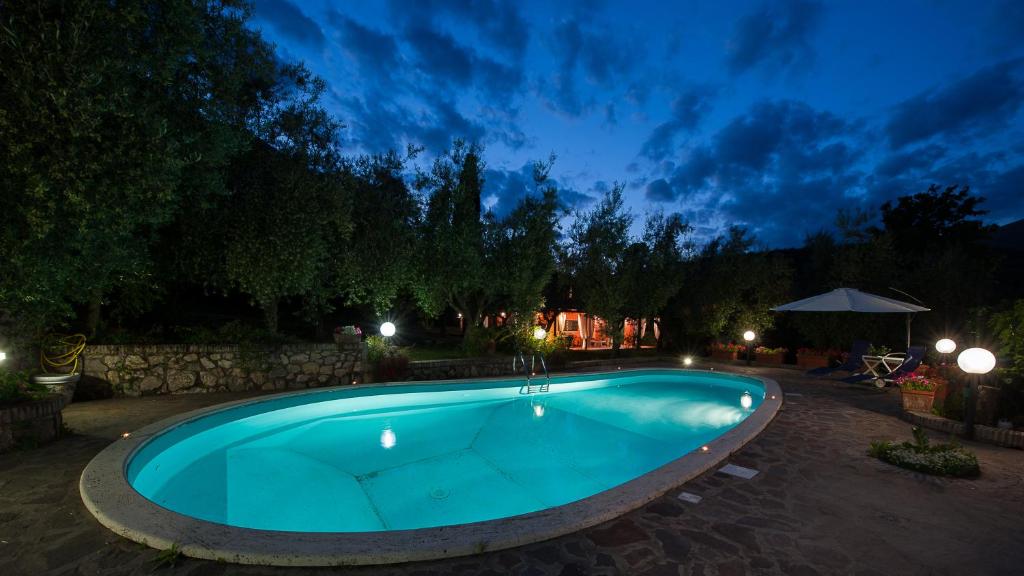 a swimming pool in a yard at night at Villa Tara Gaeta in Gaeta