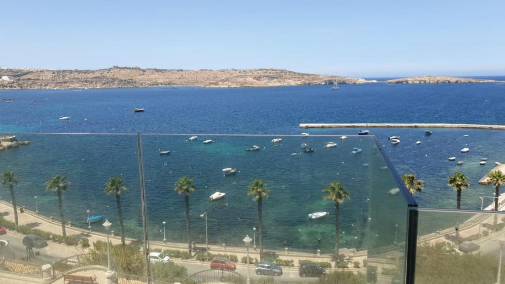 a view of a large body of water with boats at Flat 2 Blue Waves in St Paul's Bay