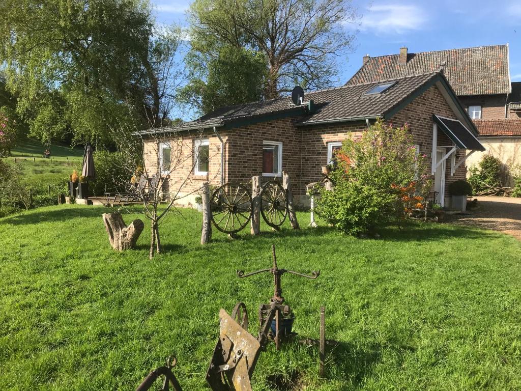 a house with a bicycle in front of a yard at Maison Marguerite in Lemiers