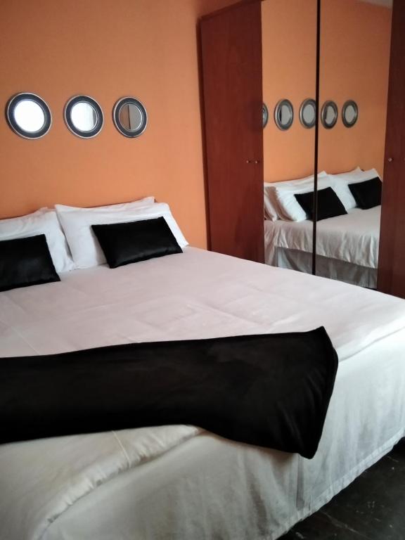 a bedroom with two beds and a mirror at Aurora... Pisos en alquiler Granada. Armilla in Armilla