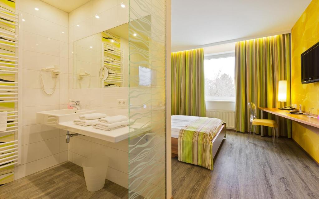 a bathroom with a sink and a shower at Motel Baden in Baden