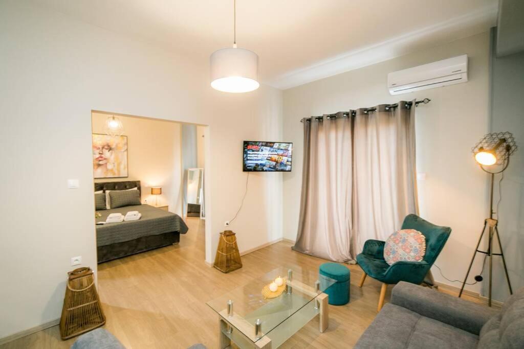 a living room with a bed and a couch at Belajo Central Apartment And Jacuzzi !! in Volos