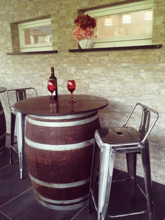 a barrel table with a bottle of wine and two chairs at Hotel Sereno in Sestri Levante
