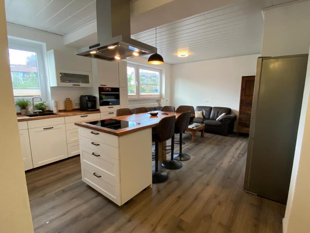 a kitchen with a island in the middle of a room at Ferienwohnung im Stadtzentrum in Oberstaufen