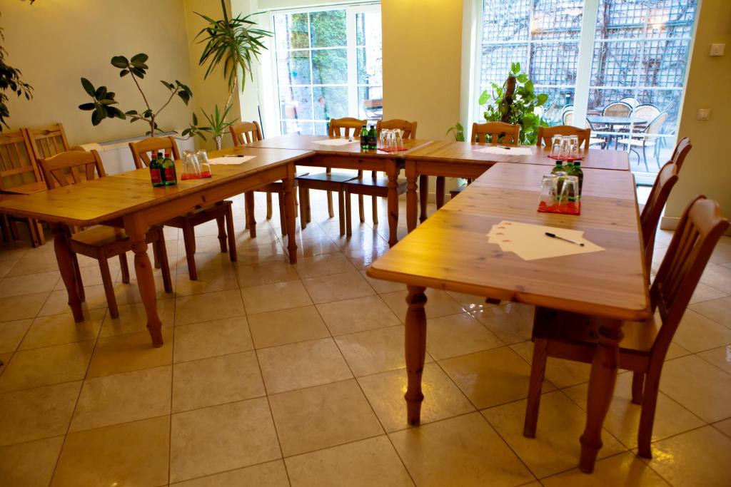 a dining room with wooden tables and chairs at Mathias Rex in Szentendre