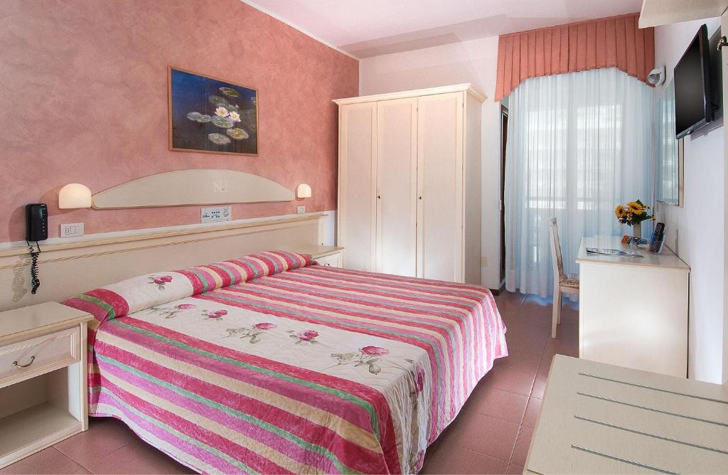 Postel nebo postele na pokoji v ubytování Hotel Napoleon