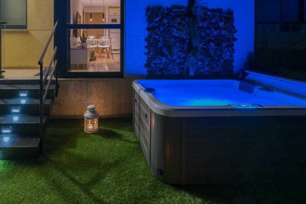 a bath tub in a room with green grass at Garden Fisterra - Jacuzzi, Jardín Privado y Vista Mar in Fisterra