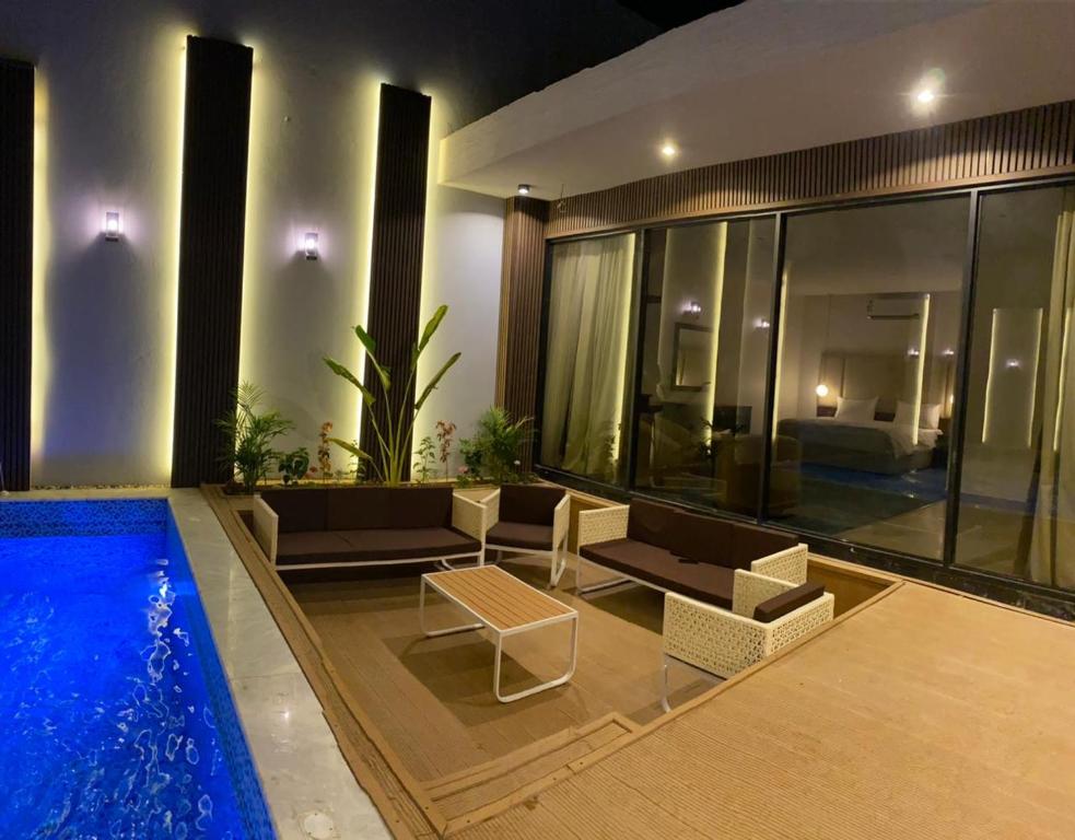 uma casa com piscina e sala de estar em منتجع ويستن Westin Chalet em Taif