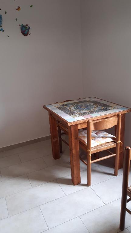 a wooden table and a chair with a table at Affittacamere da Angela in Borgorose