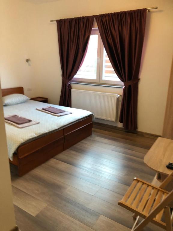 Postel nebo postele na pokoji v ubytování Pensiunea Giulia Home