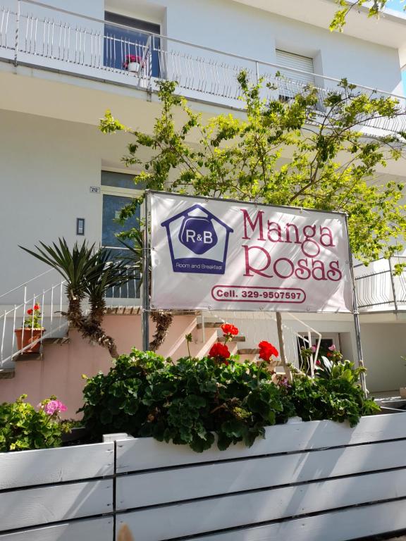 a sign for a marina rocks cafe in front of a building at R&B Manga Rosas in Lido di Dante