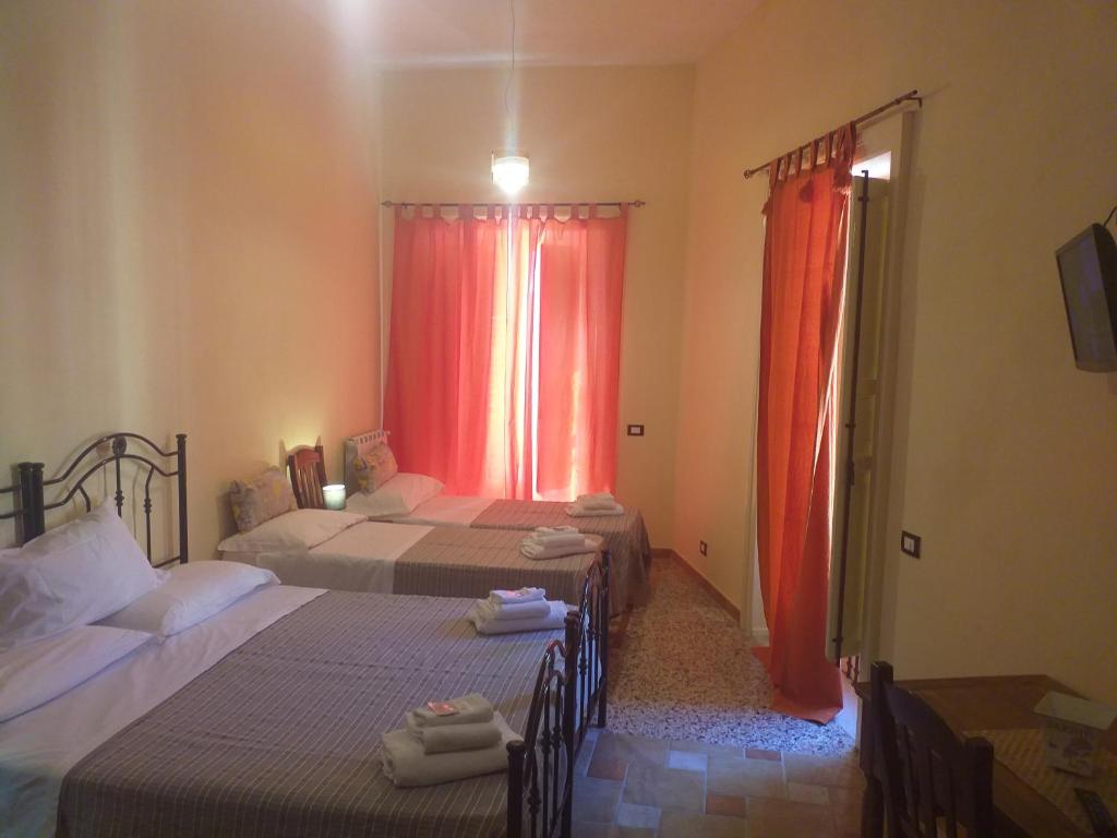 Posteľ alebo postele v izbe v ubytovaní B&B Batarà - "La Terrazza del Centro"